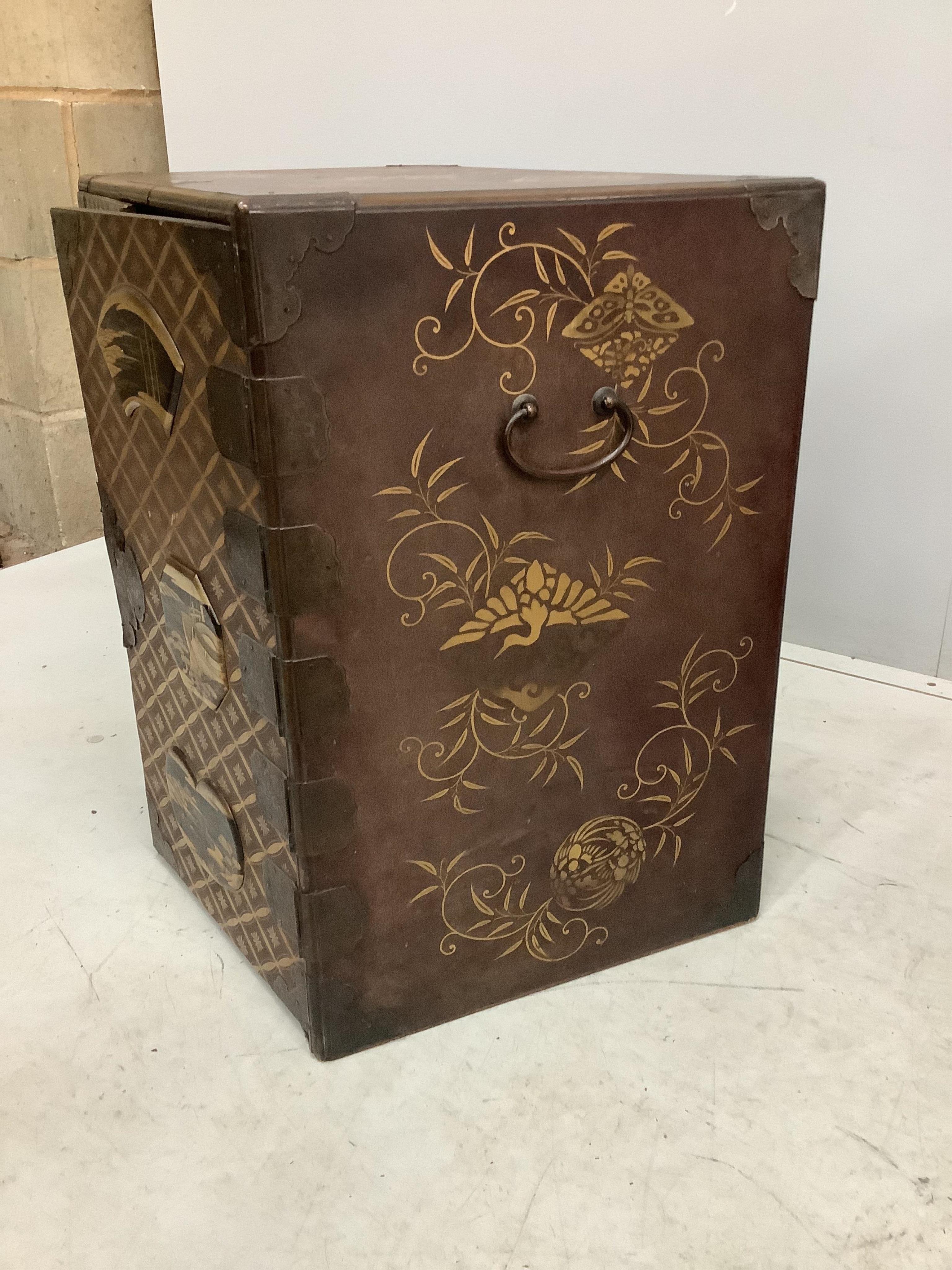 A 19th century Japanese gilt decorated lacquer table cabinet with two doors enclosing three drawers, width 61cm, depth 36cm, height 54cm. Condition - fair to good